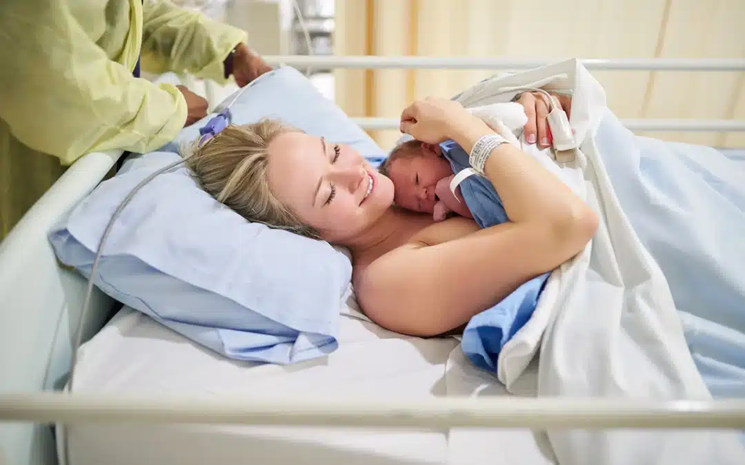 motherhood and woman with newborn healthcare or love for baby on bed