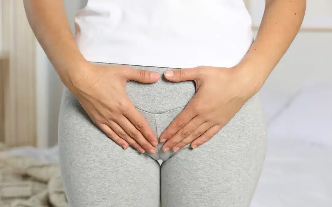 woman with hands on her crotch area